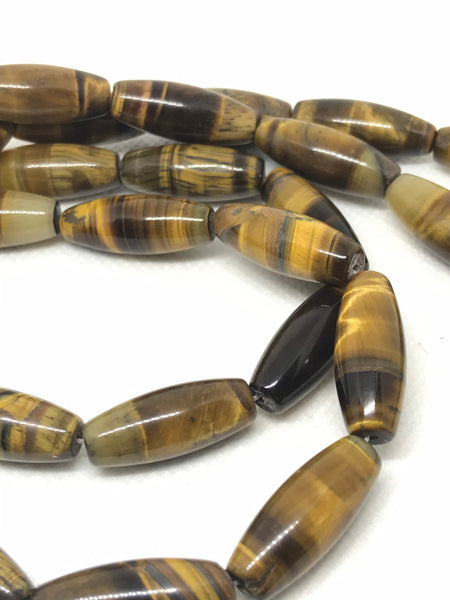 Tiger Eye Oval Barrel Plain 10x25 mm. Yellow color,16 inch full strand.One of a kind, very creative style.Black & yellow Color (# 1166 )